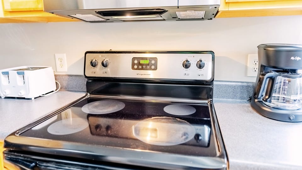 Mighty Little Beach features a fully-equipped kitchen, which incudes an electric stove/oven, a microwave, and a full-sized refrigerator.