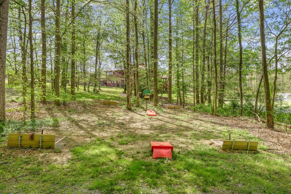Two competition horseshoe pits, cornhole, and a tetherball pole.  What fun!