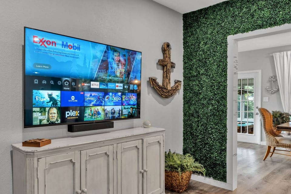 Cozy media nook with mounted TV and stylish accent wall.