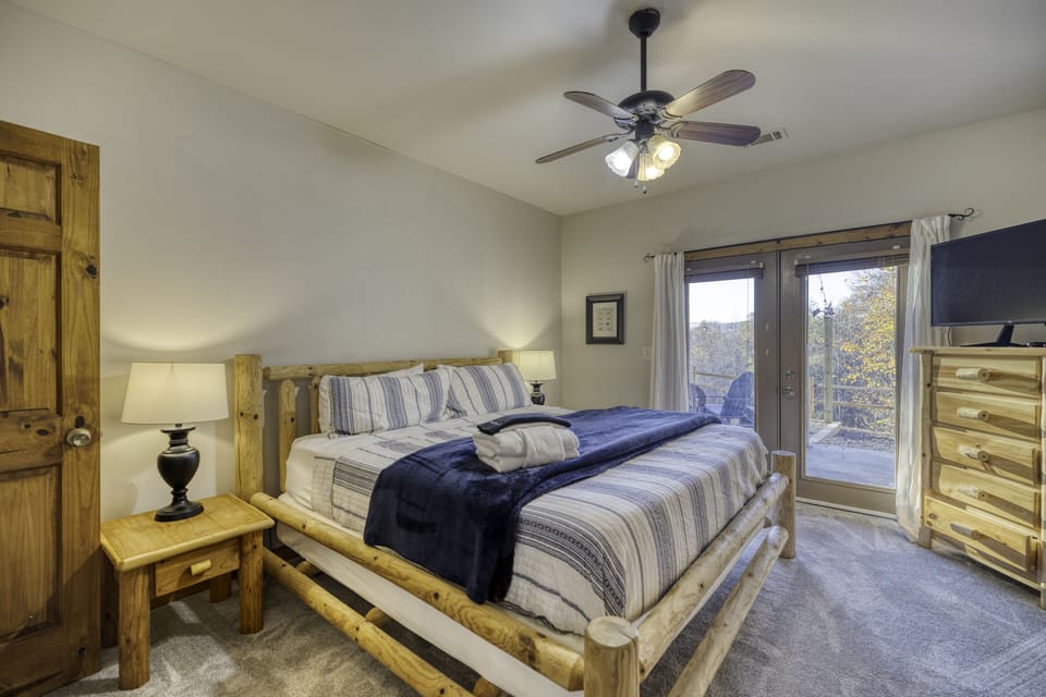 King bedroom on lower level, opens to patio with hot tub and fire pit!