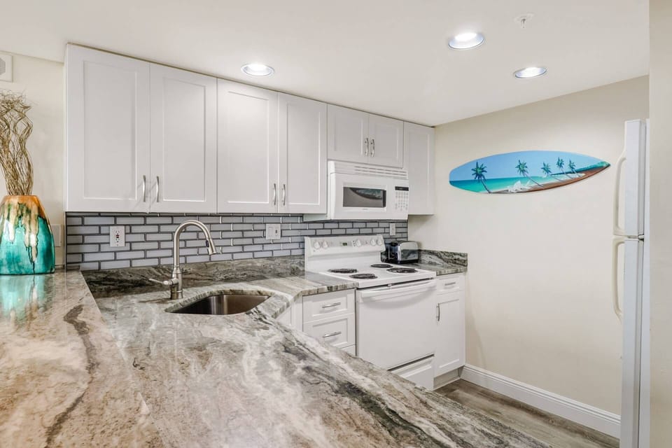 The newly updated kitchen is finished with beautiful counters, tile backplash and full size appliances.