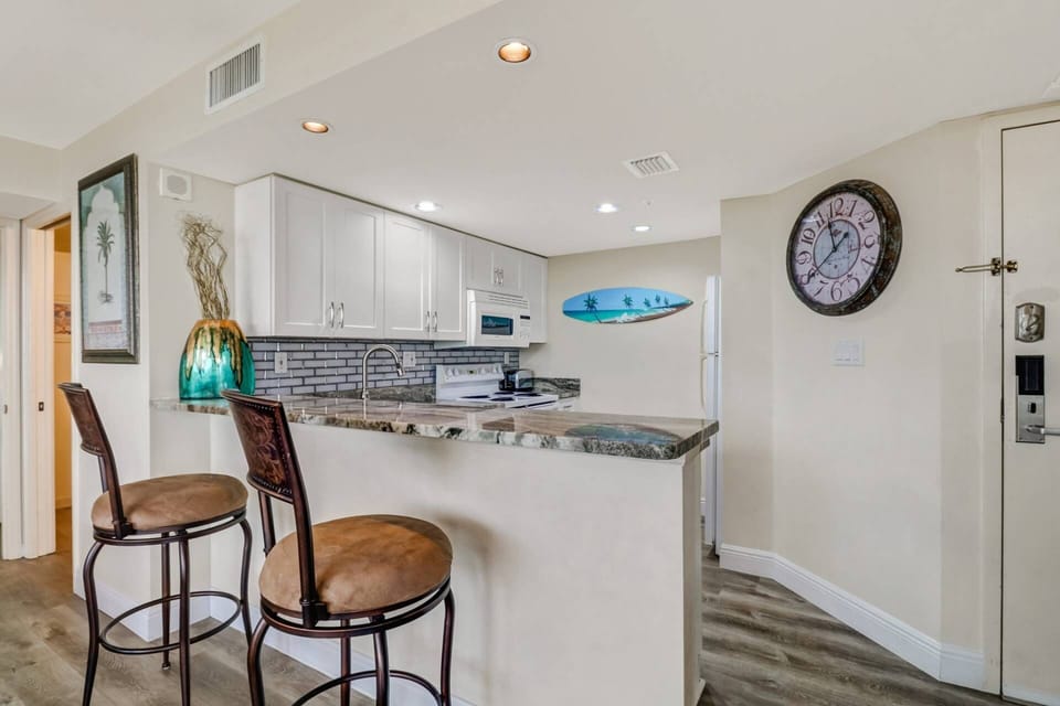 A pair of barstools at the eating bar provide a great spot to eat a quick meal or chat with the cook.