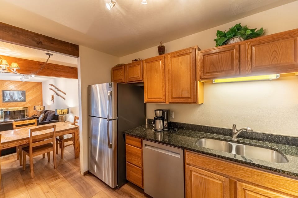 Your fully equipped kitchen features granite countertops, stainless steel appliances, and everything you need to prepare memorable meals during your mountain getaway.