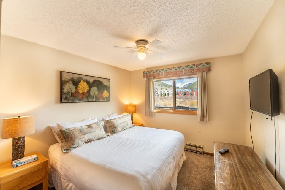 Unwind in your cozy bedroom with mountain views, warm lighting, and all the comforts of home for a perfect alpine retreat.