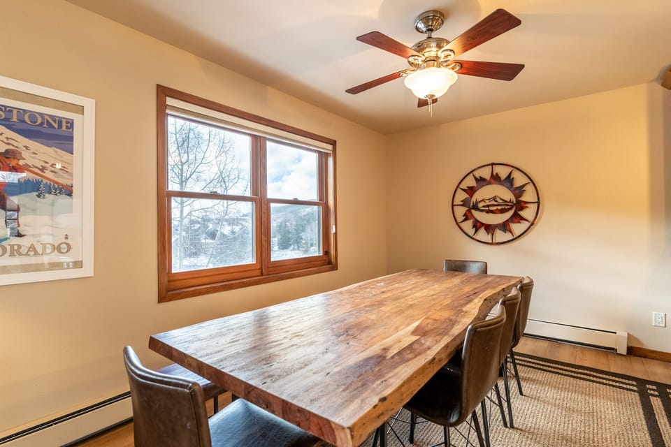 Gather around this rustic wooden dining table where meaningful conversations flow as naturally as the mountain breeze through your windows.