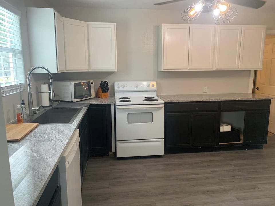 Spacious kitchen with dishwasher, microwave, stove plenty of room not to run into anyone. 