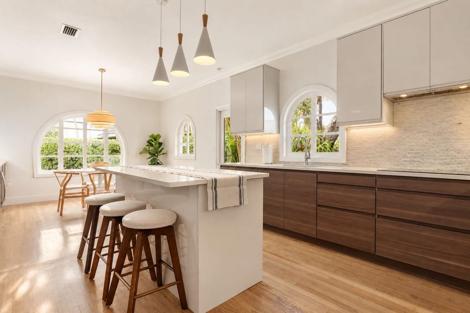 Pull up to the white barstools for morning coffee and the tile backsplash and dark wood cabinets provide a clean workspace for prepping meals.