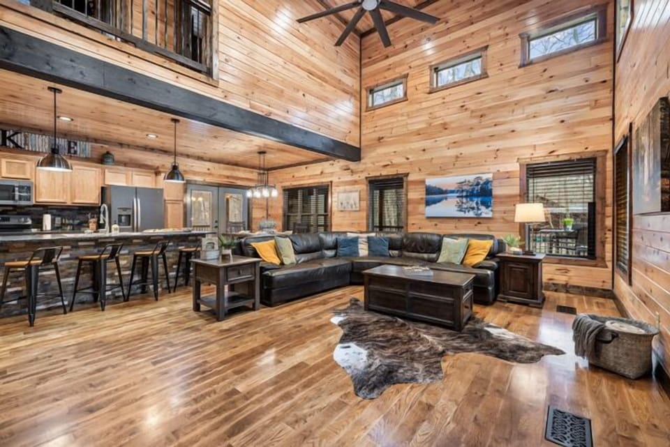 Open living area. Genuine leather sectional. Custom stone fireplace.