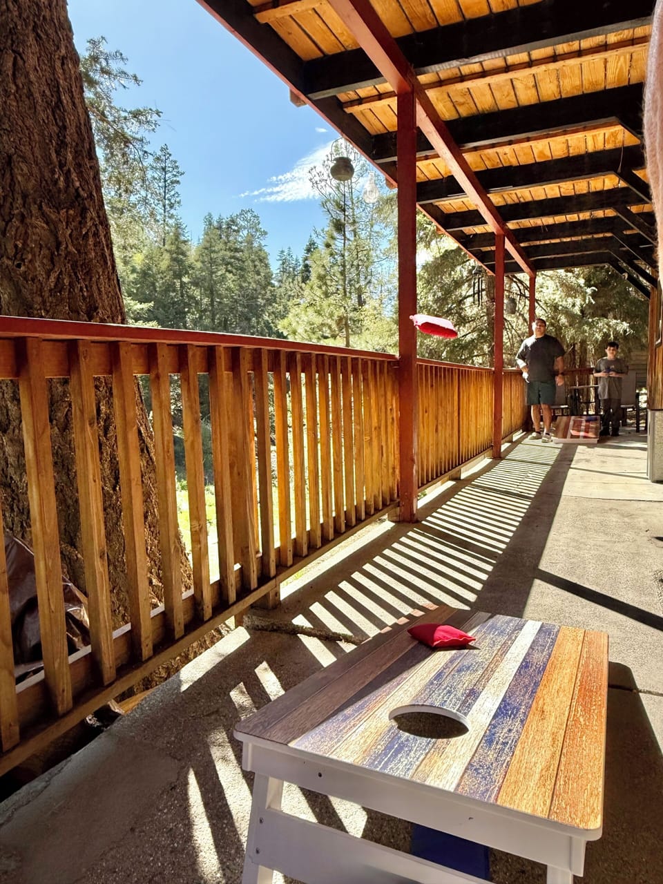 Compete with one another playing corn hole on the lower back patio.