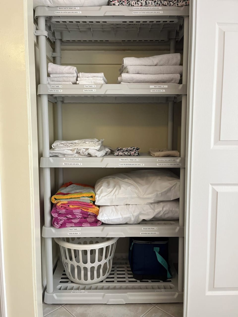 Linen closet with supplies. 2 beach towels and additional sleeper sofa items. 