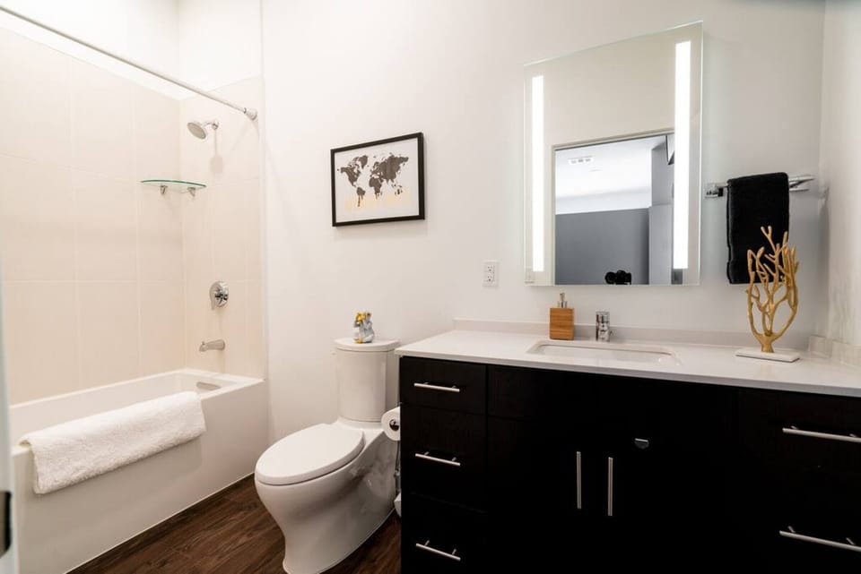 Modern full size bathroom with shower, tub and toilet.