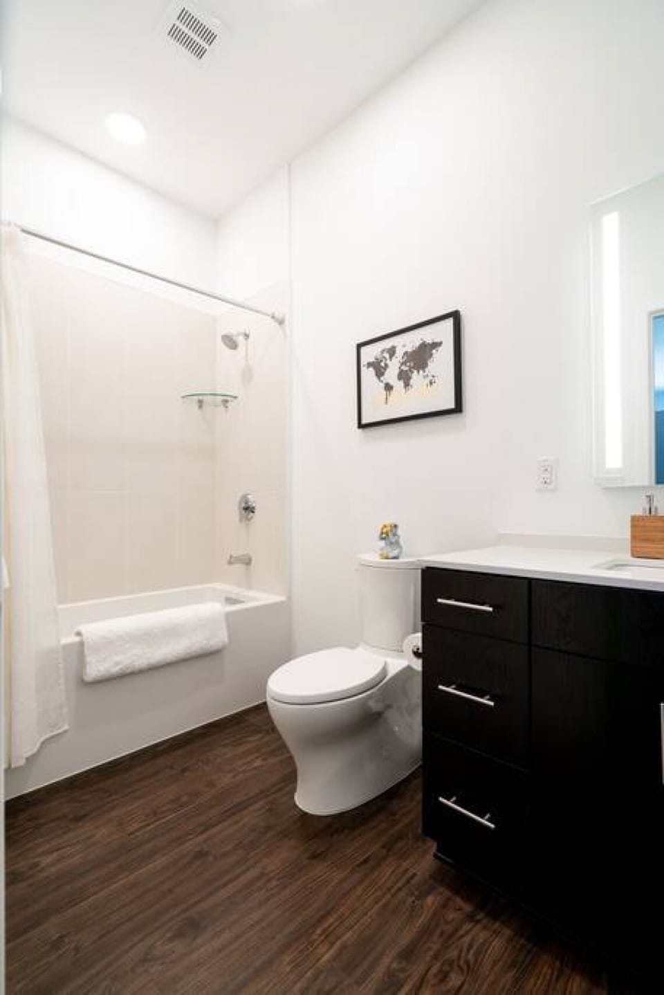 Modern full size bathroom with shower, tub and toilet.