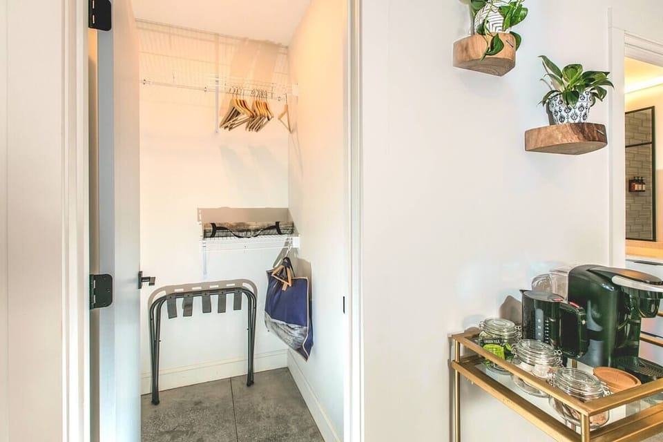 Spacious Closet with Hangers, Luggage Rack, and Ironing Board