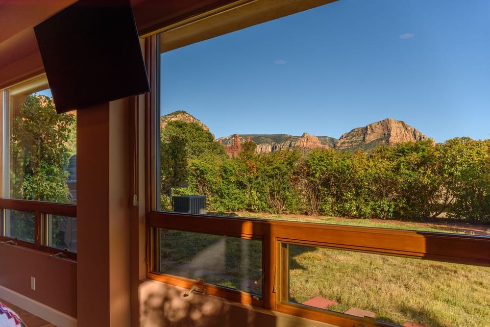 Full wall of windows with views from casita