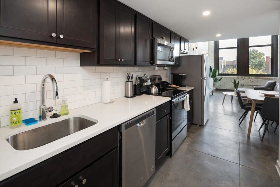 Enjoy home-cooked or the neighborhood's best takeout in this lovely kitchen with stainless steel appliances, a microwave, and a full-sized refrigerator