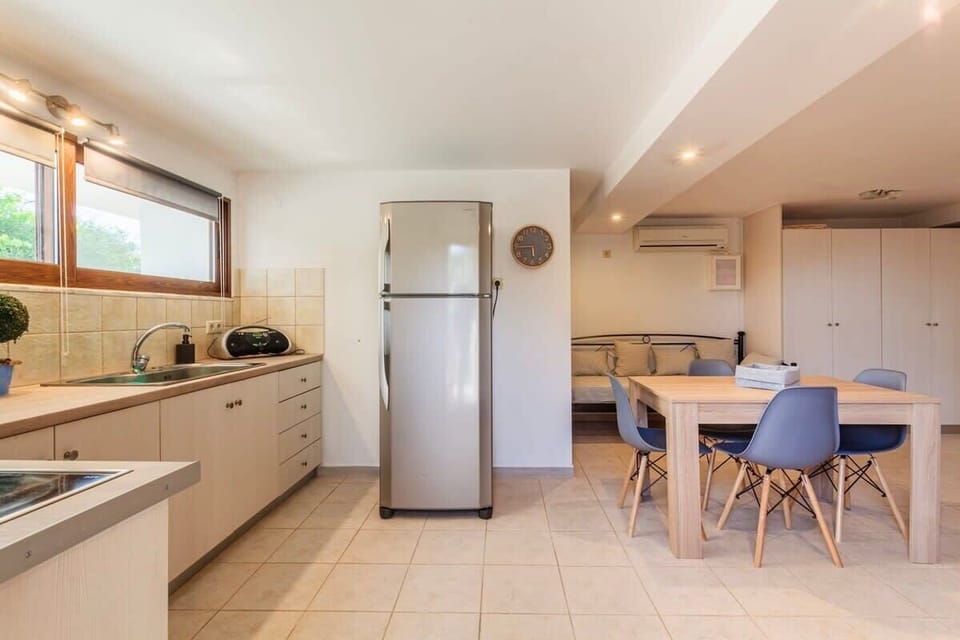 The property offers a fully equipped kitchen and a spacious dining area