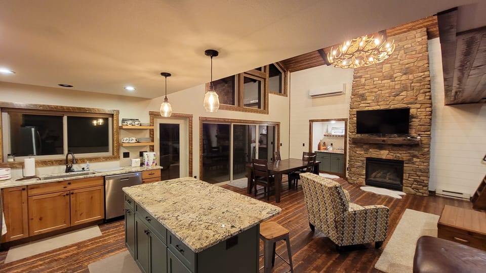 Kitchen with stainless appliances and granite counter tops.  Dining table.