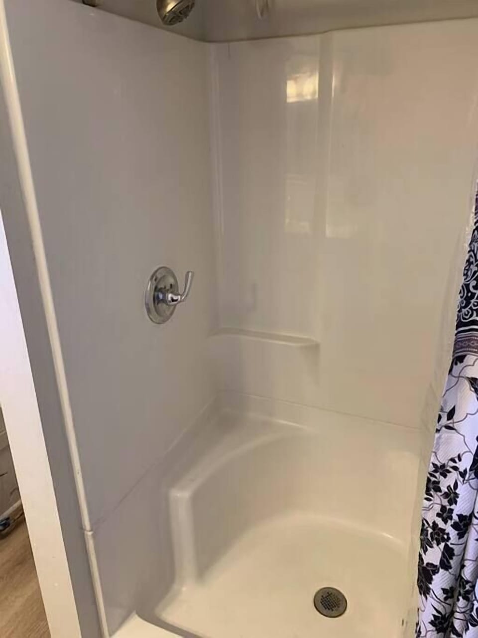 The first floor bath features a shower, with only a small step clearance