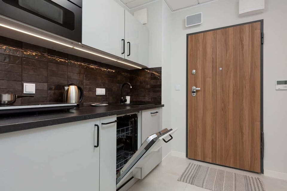 The modern kitchenette has a dishwasher, hob and microwave to cook home-cooked meals.