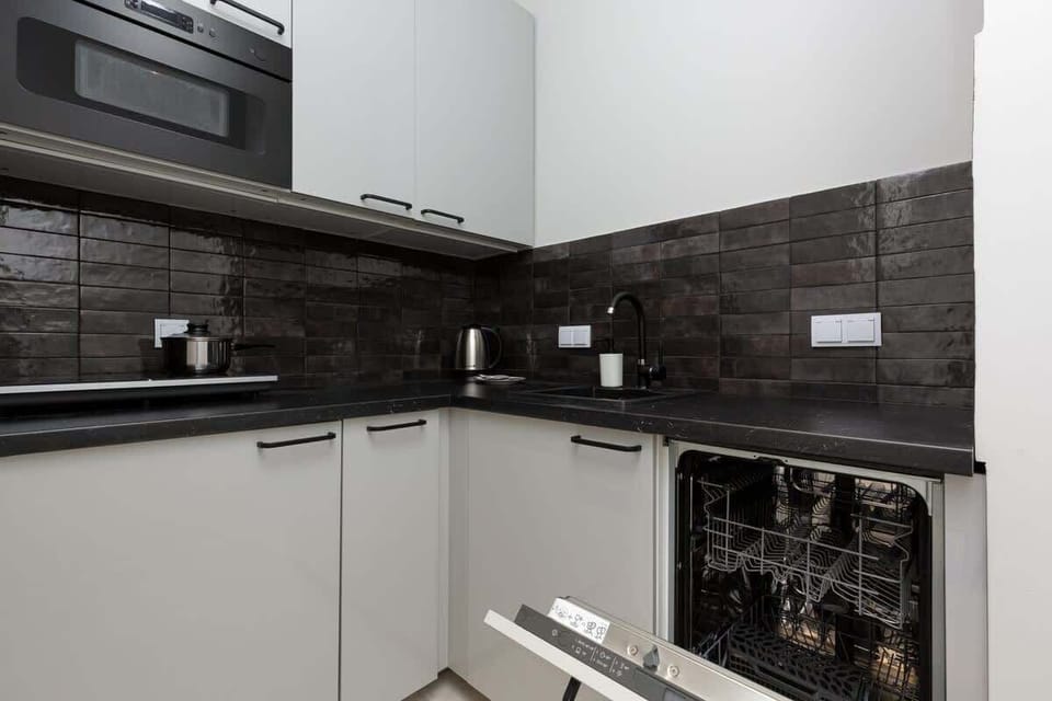 The kitchen is equipped with high-quality appliances that ensure the preparation of home-cooked meals.