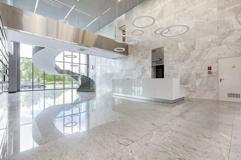 Bright, representative lobby lined with tiles imitating marble.