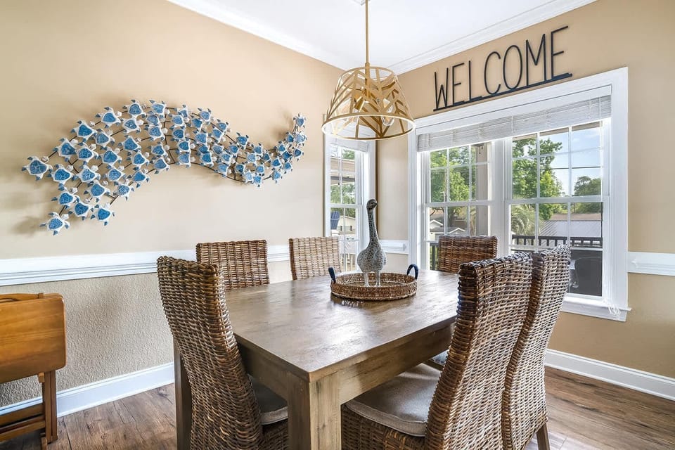 Bright dining room with coastal decor and garden views