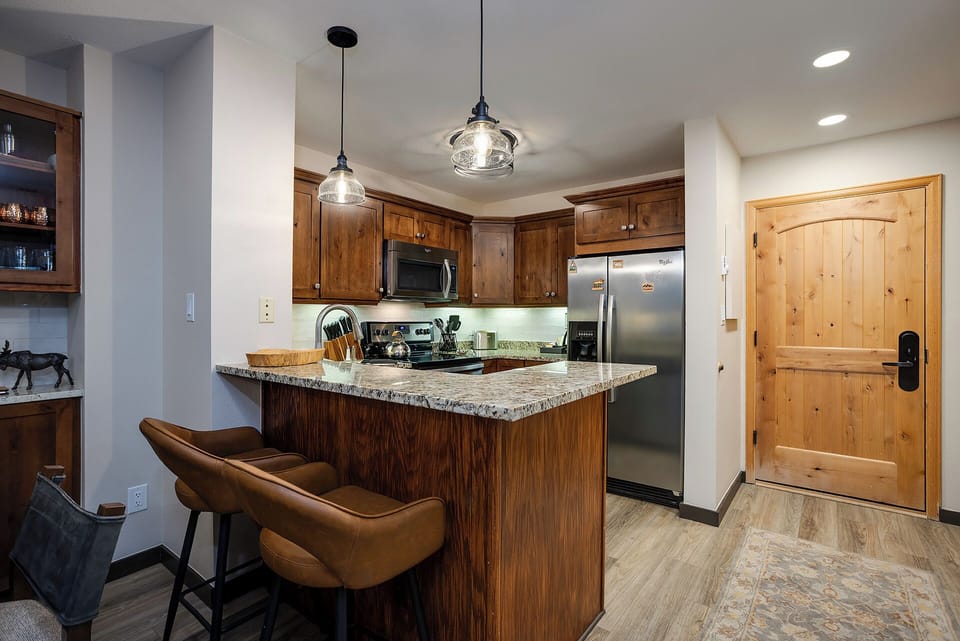 Your fully-equipped kitchen invites culinary adventures with granite counters, stainless appliances, and cozy breakfast bar seating.