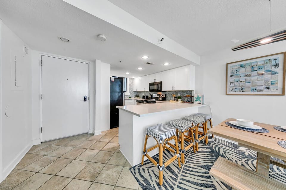 Your bright, modern kitchen invites culinary creativity with its white cabinets, granite counters, and spacious island perfect for morning coffee or casual dining.