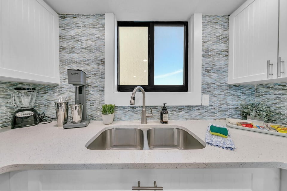 Your fully-equipped kitchen features gleaming countertops, modern appliances, and a sparkling double sink perfect for preparing your favorite meals.
