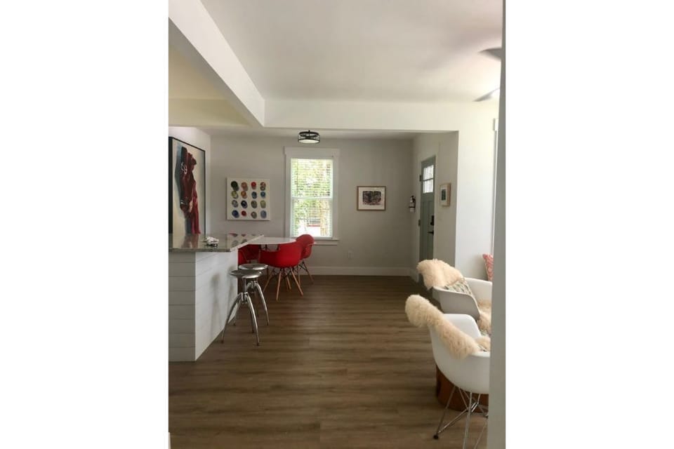 View from hallway to living area and dining area 