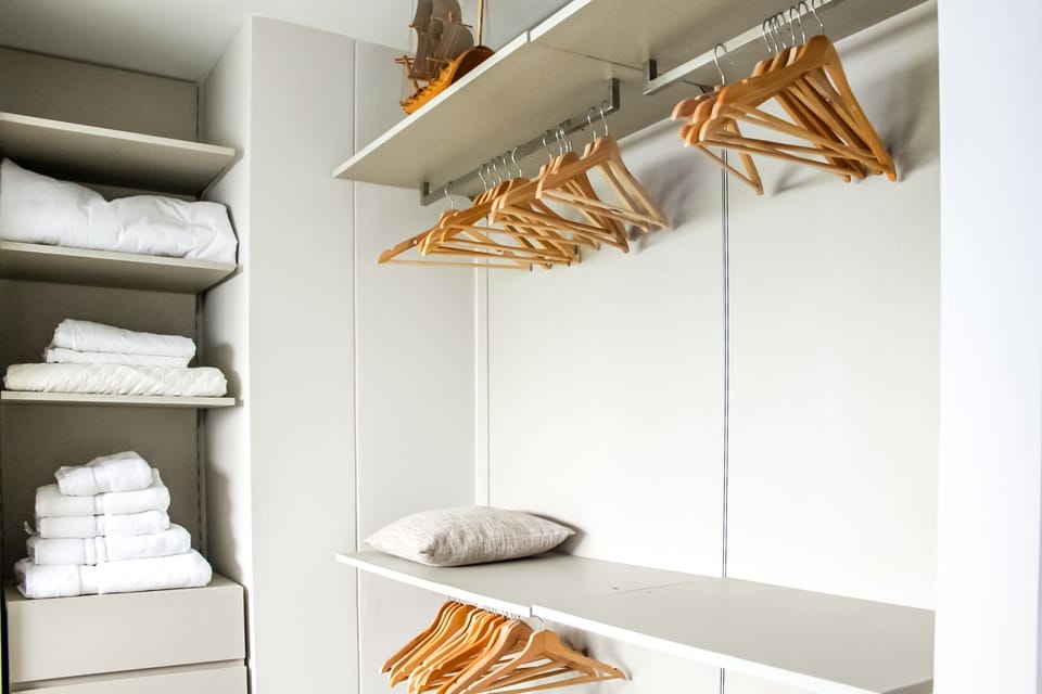 Fully Stocked Bathroom with Hangers and Closet.