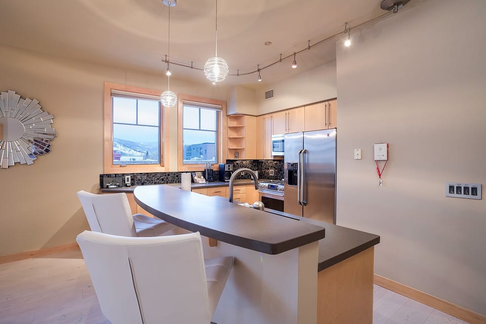 Your modern kitchen features sleek stainless appliances, stunning mountain views, and a stylish island where you can prepare meals and gather.