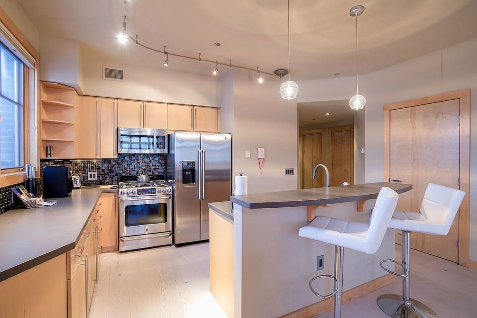 Your modern kitchen awaits with stainless steel appliances, granite counters, and a breakfast bar perfect for morning coffee.