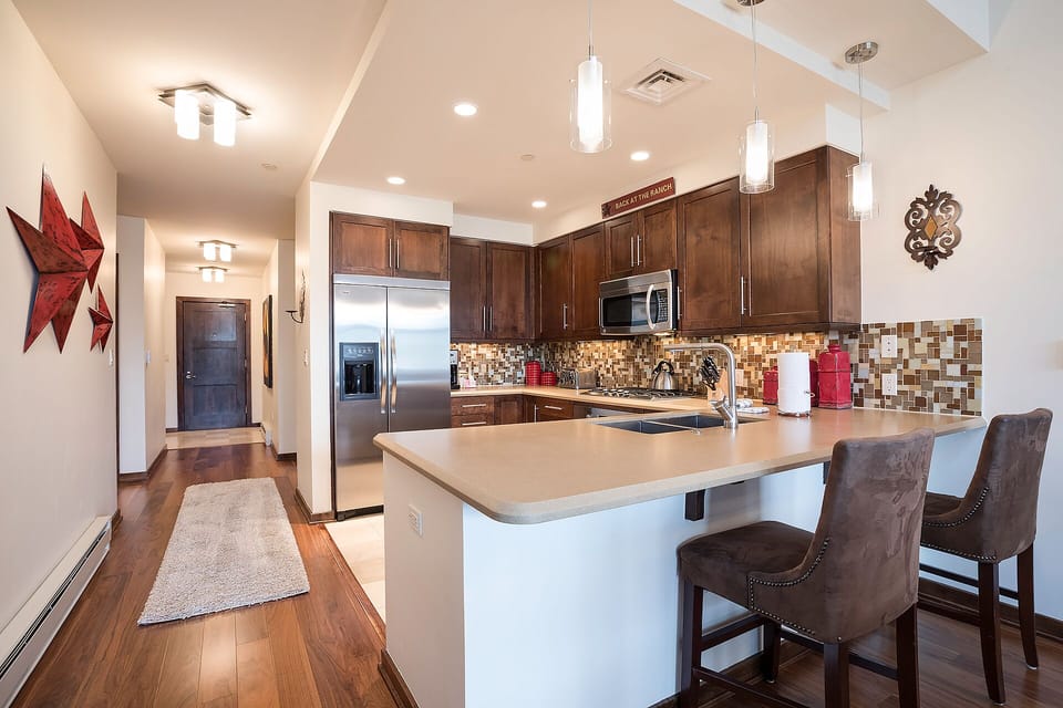 Your gourmet kitchen features rich walnut cabinetry, gleaming granite counters, and premium stainless steel appliances for memorable home-cooked meals.