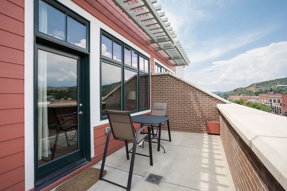 Step onto your private rooftop terrace with mountain views and outdoor dining space for morning coffee or evening relaxation.
