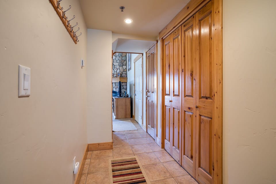 Step into your welcoming entryway with warm wood details, coat hooks for your gear, and tile flooring that flows seamlessly throughout your mountain retreat.
