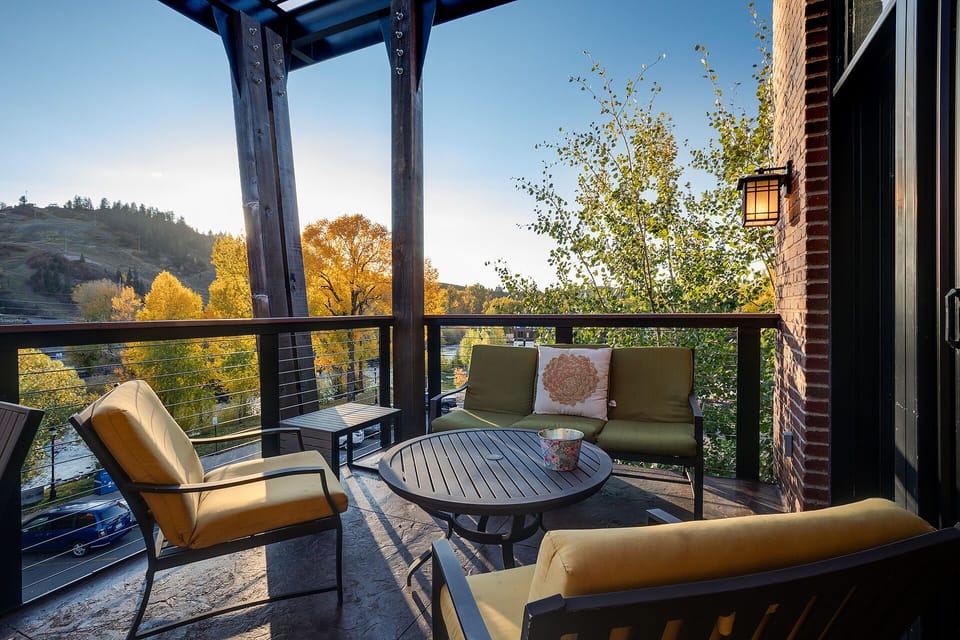 Unwind on your private covered terrace with comfortable seating and stunning autumn views of rolling hills and colorful foliage.