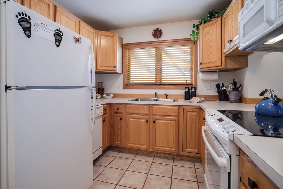 Your fully equipped kitchen awaits with warm wood cabinets, modern appliances, and everything you need to create delicious meals during your stay.