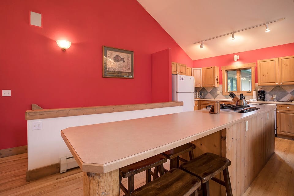 Your spacious kitchen features warm wood cabinetry, granite countertops, and a breakfast bar perfect for casual meals together.