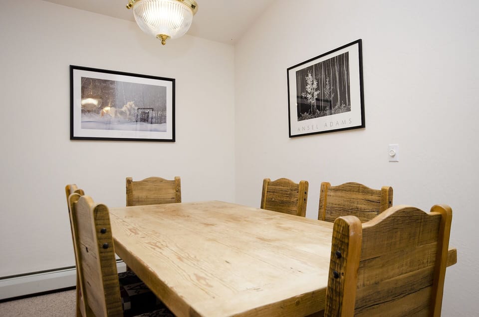 Your rustic dining space awaits with warm wood tones and elegant lighting for memorable meals together.