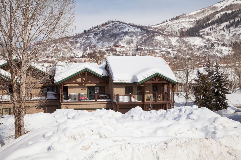 Winter mountain lodge property surrounded by pristine snow and majestic peaks.
