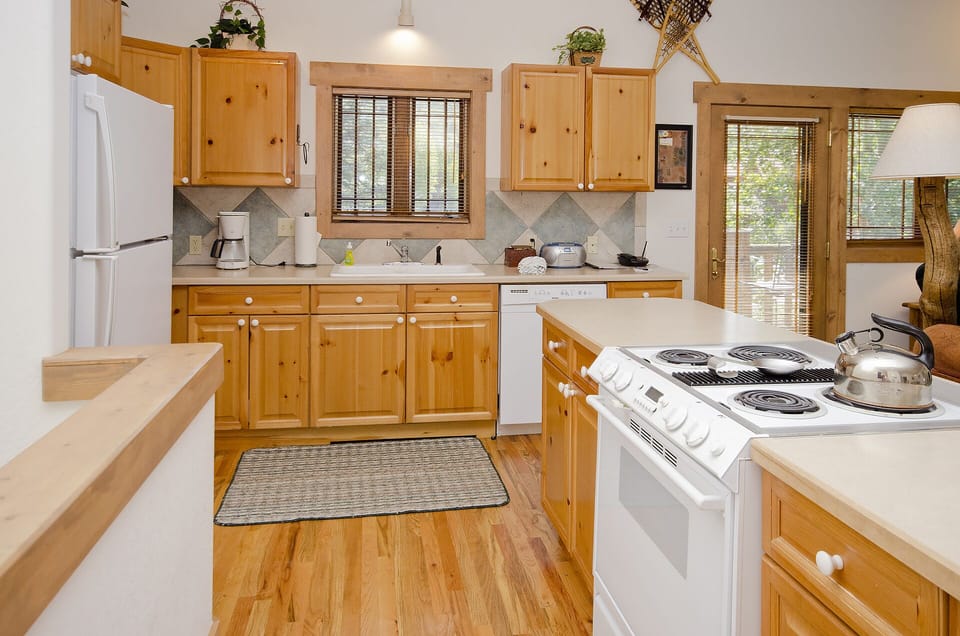 Your fully-equipped kitchen features warm wood cabinets, full-size appliances, and everything you need to prepare delicious meals during your stay.