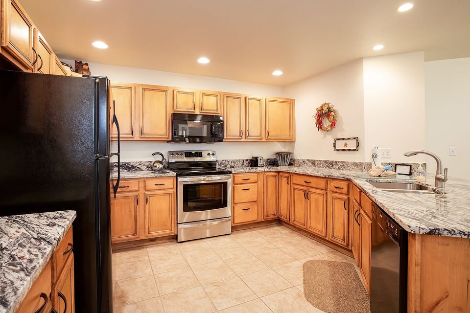 Your fully equipped kitchen awaits with granite countertops, stainless appliances, and ample cabinet space for preparing memorable meals together.