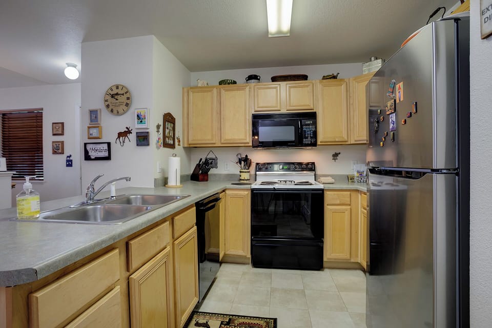 Your fully equipped kitchen features stainless steel appliances and warm wood cabinets, perfect for preparing meals during your stay.