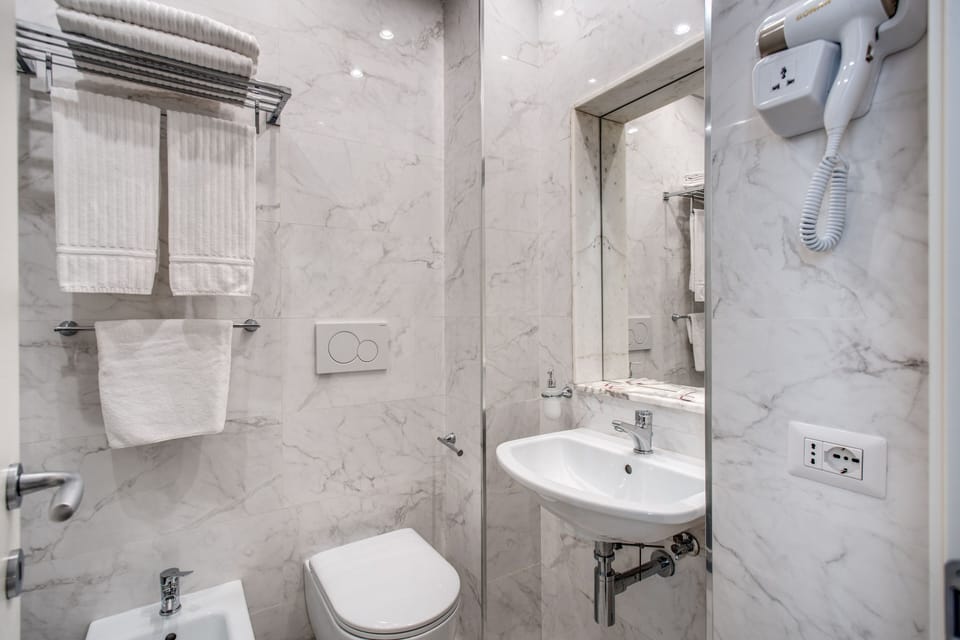 Economy Double Room | Bathroom | Separate tub and shower, free toiletries, hair dryer, slippers