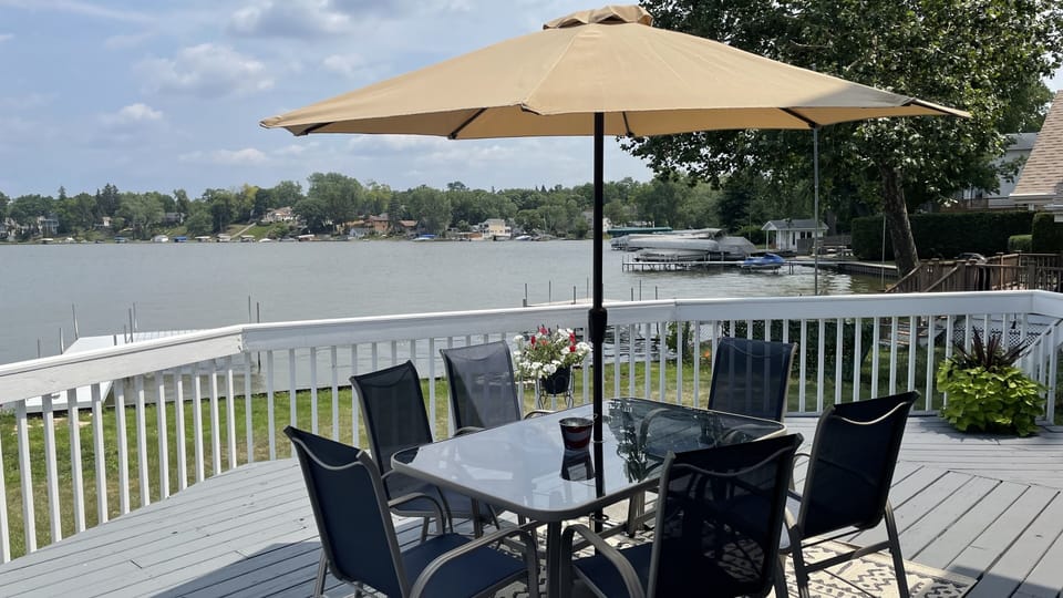 Large, sunny exterior deck area with seating for six and views of Mineola Bay