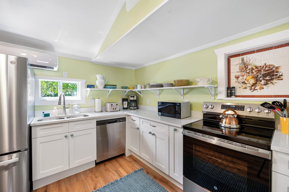 New kitchen with dishwasher, smooth top electric range and microwave
