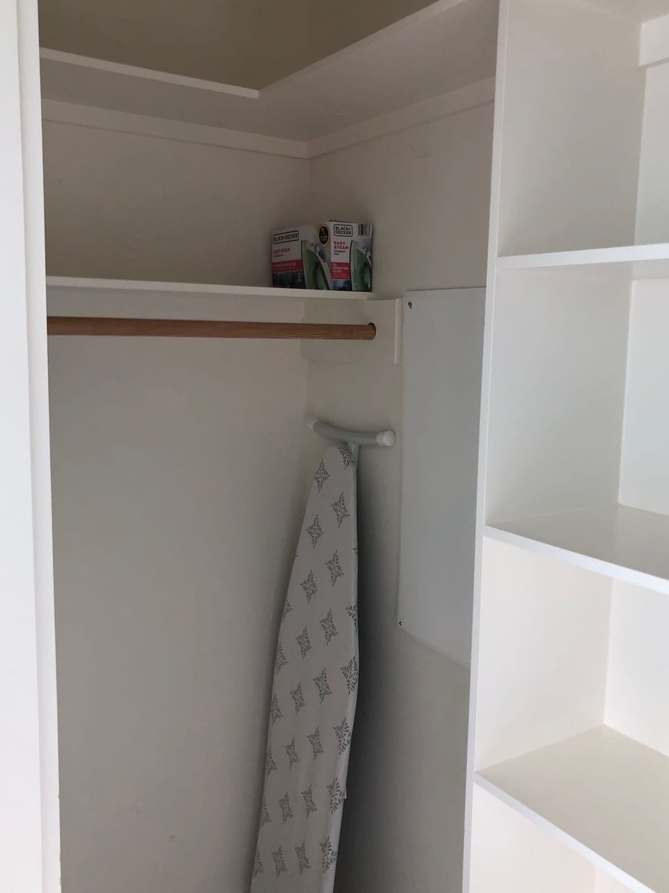 Iron And ironing board in closet 