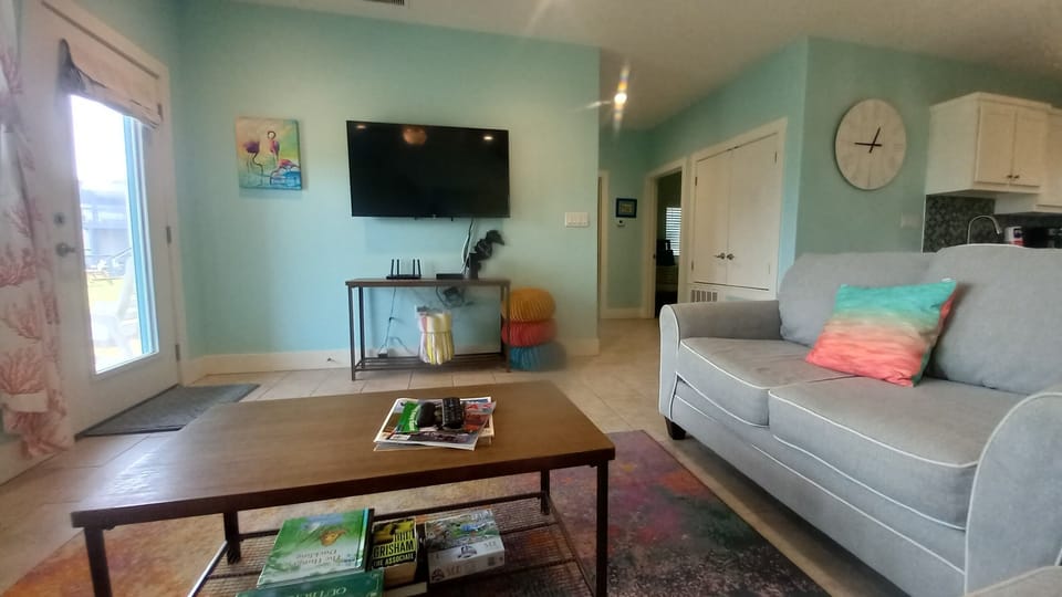 Living room with smart tv, books games, and magazines