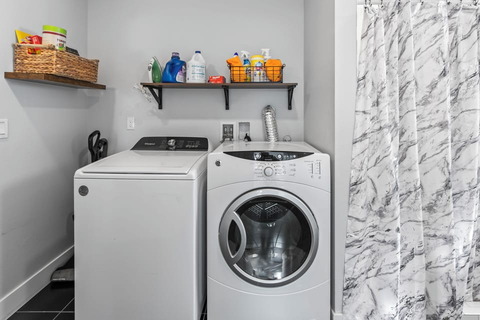 Washer/dryer, laundry soap, cleaning supplies, iron/board, game basket. 